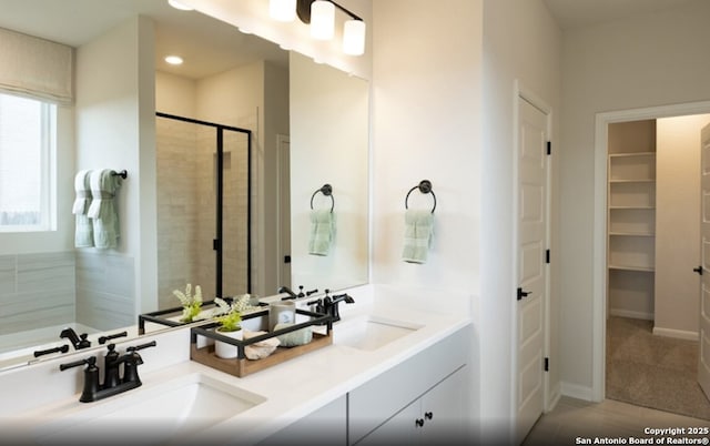 14426 Daphne Bnd, San Antonio, TX 78253 - full bath with a stall shower, double vanity, a walk in closet, tile patterned floors, and recessed lighting