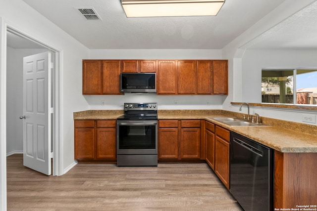 221 Passerina Spur, Schertz, TX 78154 - kitchen with stainless steel range with electric stovetop, dishwasher, brown cabinets, and light wood finished floors