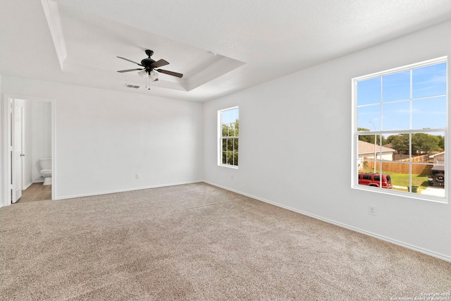 221 Passerina Spur, Schertz, TX 78154 - empty room featuring light carpet, a tray ceiling, and a ceiling fan