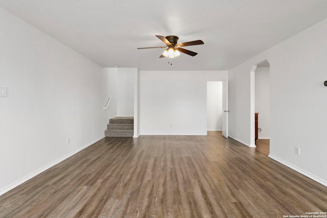 221 Passerina Spur, Schertz, TX 78154 - spare room featuring a ceiling fan, wood finished floors, stairway, and arched walkways