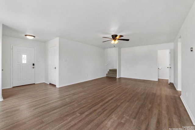 221 Passerina Spur, Schertz, TX 78154 - unfurnished living room with ceiling fan, stairs, and dark wood-style flooring