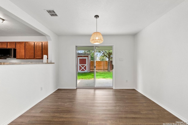 221 Passerina Spur, Schertz, TX 78154 - unfurnished dining area featuring dark wood finished floors and baseboards