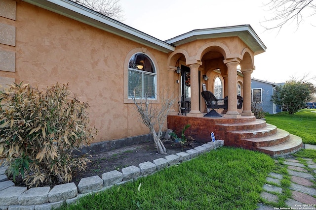 402 Hermine Blvd, San Antonio, TX 78212 - doorway to property with stucco siding, a yard, and covered porch