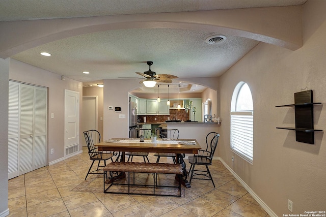 402 Hermine Blvd, San Antonio, TX 78212 - dining room with light tile patterned floors, a ceiling fan, a textured ceiling, arched walkways, and recessed lighting