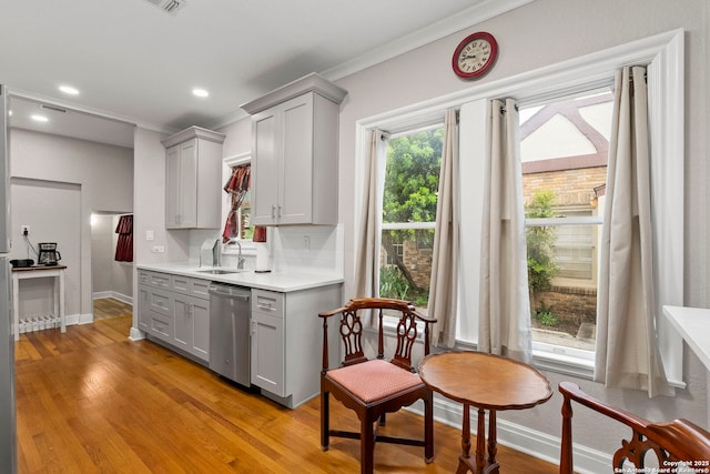 138 E Lullwood Ave, San Antonio, TX 78212 - kitchen with dishwasher, gray cabinetry, light countertops, ornamental molding, and light wood-style floors