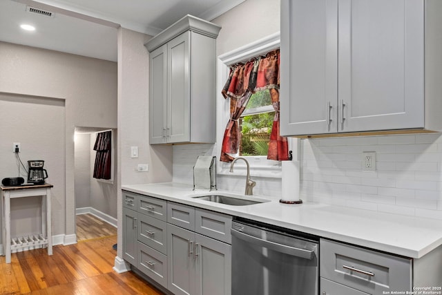 138 E Lullwood Ave, San Antonio, TX 78212 - kitchen featuring dishwasher, gray cabinetry, tasteful backsplash, light wood finished floors, and light countertops
