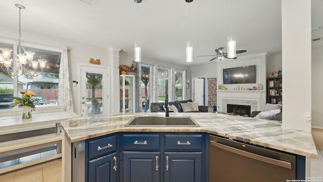1739 Oak Gln, New Braunfels, TX 78132 - kitchen featuring stainless steel dishwasher, blue cabinetry, open floor plan, light tile patterned flooring, and a fireplace