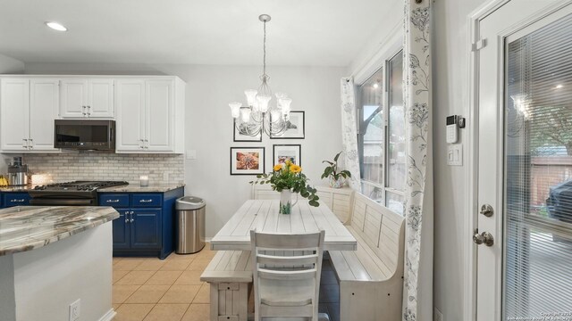 1739 Oak Gln, New Braunfels, TX 78132 - kitchen featuring blue cabinets, decorative backsplash, white cabinets, plenty of natural light, and recessed lighting