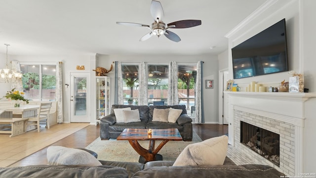 1739 Oak Gln, New Braunfels, TX 78132 - living room with ceiling fan, a chandelier, and a fireplace