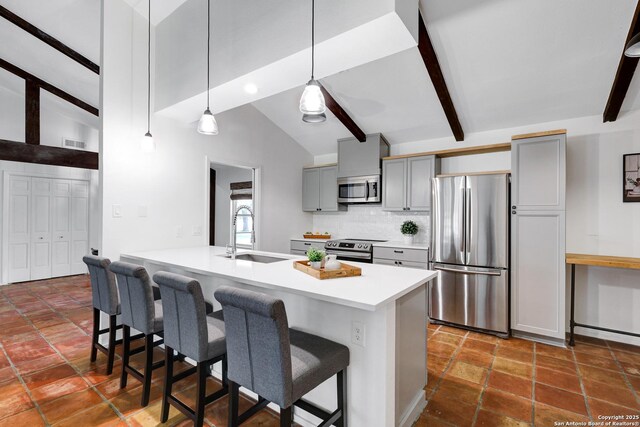 2116 Turkey Ledge, San Antonio, TX 78232 - kitchen with stainless steel appliances, gray cabinets, a kitchen bar, beamed ceiling, and backsplash