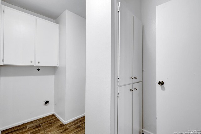 2116 Turkey Ledge, San Antonio, TX 78232 - laundry area with cabinet space, dark wood finished floors, and hookup for an electric dryer