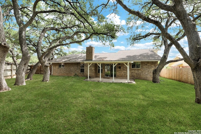 2116 Turkey Ledge, San Antonio, TX 78232 - rear view of property featuring brick siding, a patio area, a chimney, and a fenced backyard