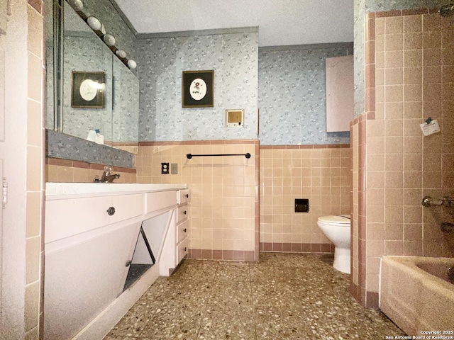 3923 Maxine, San Antonio, TX 78228 - bathroom with wallpapered walls, tile walls, wainscoting, vanity, and tub / shower combination