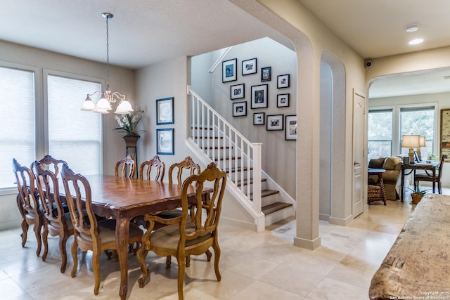 108 Brown Hawk, Boerne, TX 78006 - dining space with arched walkways, stairway, light tile patterned floors, and a chandelier
