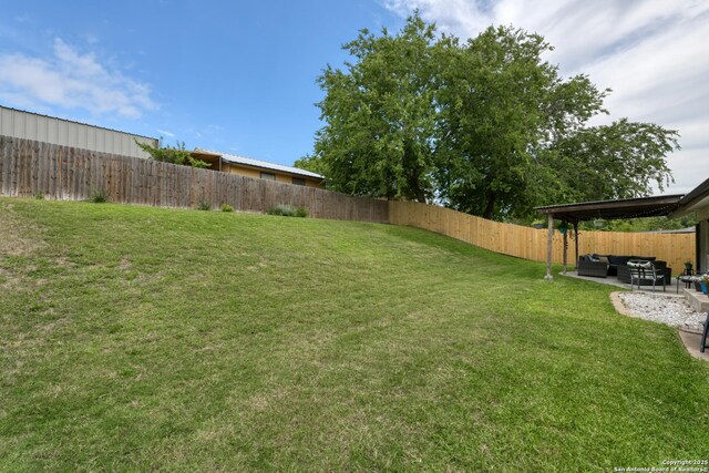 8211 Littleport, San Antonio, TX 78239 - fenced backyard featuring an outdoor hangout area and a patio area