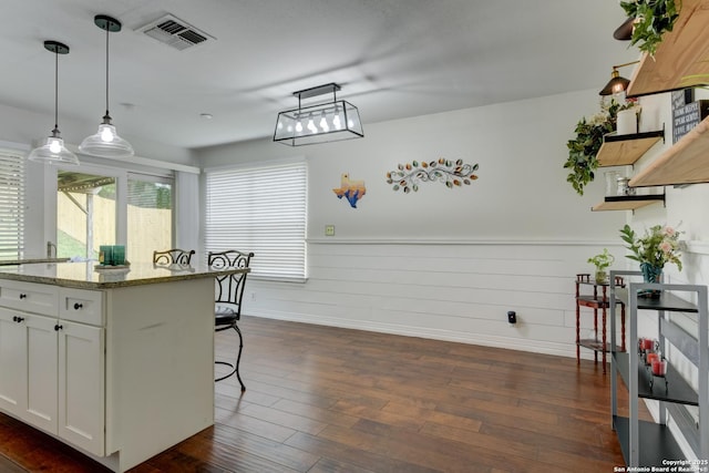 8211 Littleport, San Antonio, TX 78239 - kitchen with open shelves, a kitchen breakfast bar, dark wood-style flooring, white cabinets, and pendant lighting