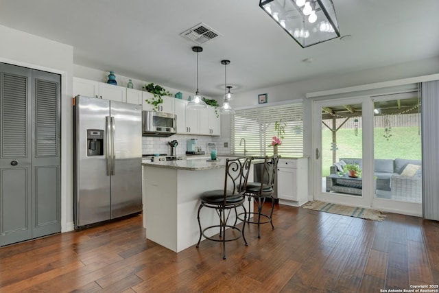 8211 Littleport, San Antonio, TX 78239 - kitchen featuring stainless steel appliances, white cabinetry, and dark wood-type flooring
