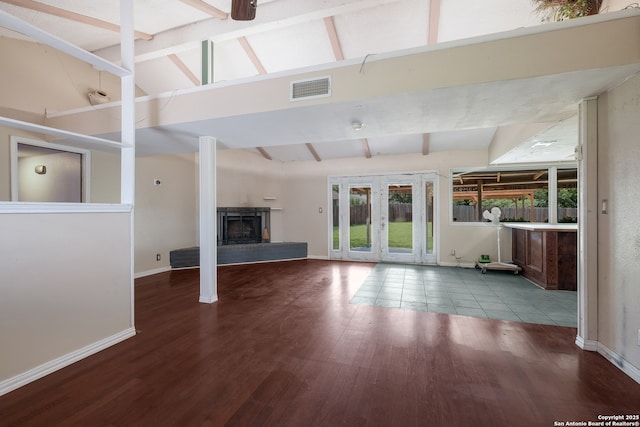 6914 Glen Gate, San Antonio, TX 78239 - unfurnished living room with wood finished floors, a fireplace with raised hearth, and french doors