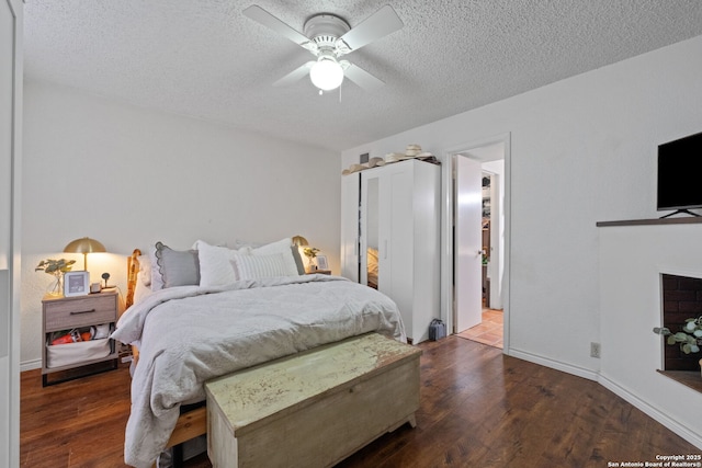 30650 Wildcat Dr, Bulverde, TX 78163 - bedroom featuring a textured ceiling, wood finished floors, and a ceiling fan