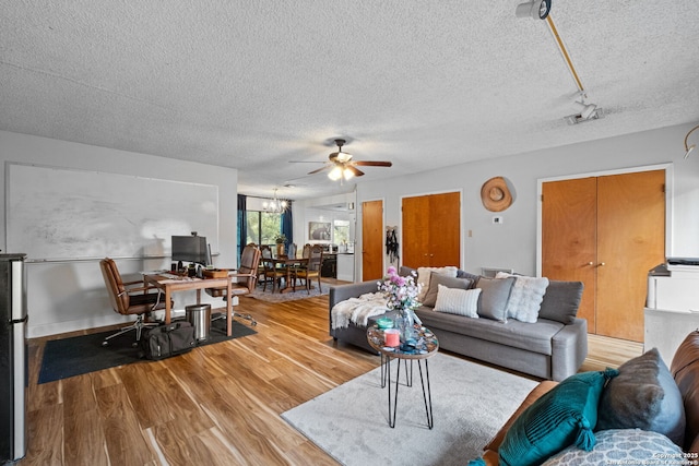 30650 Wildcat Dr, Bulverde, TX 78163 - living area featuring a ceiling fan, a textured ceiling, wood finished floors, and a chandelier