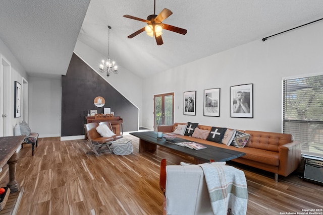 30650 Wildcat Dr, Bulverde, TX 78163 - living area featuring wood finished floors, high vaulted ceiling, a ceiling fan, a chandelier, and a textured ceiling