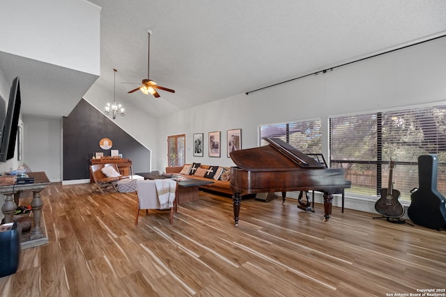 30650 Wildcat Dr, Bulverde, TX 78163 - living area with a ceiling fan, wood finished floors, high vaulted ceiling, and a chandelier