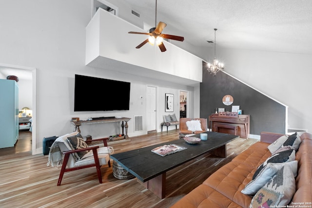 30650 Wildcat Dr, Bulverde, TX 78163 - living area with wood finished floors, ceiling fan, and high vaulted ceiling