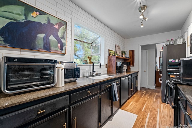 30650 Wildcat Dr, Bulverde, TX 78163 - kitchen with dishwasher, range with electric cooktop, light wood-style floors, open shelves, and dark stone countertops