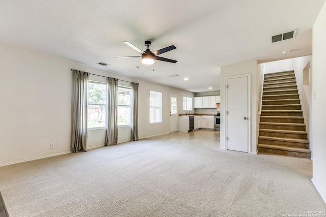 11747 Silver Pr, San Antonio, TX 78254 - unfurnished living room featuring ceiling fan, stairs, light carpet, and recessed lighting