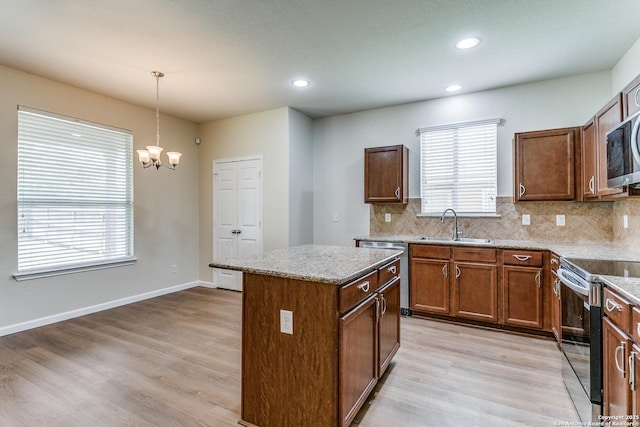 27338 Wrought Iron, San Antonio, TX 78260 - kitchen featuring stainless steel appliances, a chandelier, a kitchen island, decorative light fixtures, and backsplash