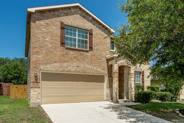 27338 Wrought Iron, San Antonio, TX 78260 - view of front of home featuring a garage, stone siding, driveway, and brick siding