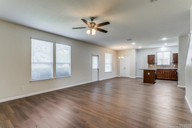 27338 Wrought Iron, San Antonio, TX 78260 - unfurnished living room with a ceiling fan, a chandelier, dark wood finished floors, and recessed lighting