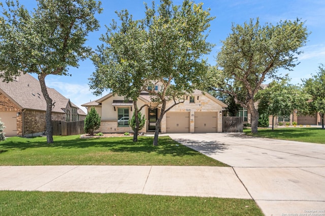 130 Boulder Crk, Boerne, TX 78006 - view of front of home featuring driveway, stone siding, an attached garage, and stucco siding