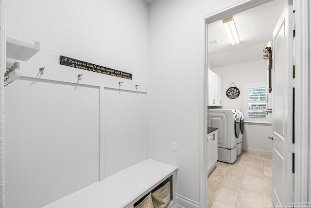 130 Boulder Crk, Boerne, TX 78006 - washroom featuring washer and dryer, cabinet space, and light tile patterned floors