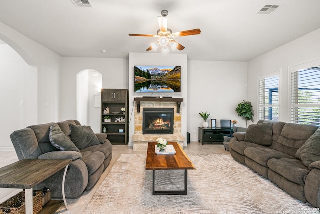 130 Boulder Crk, Boerne, TX 78006 - living area featuring arched walkways, a ceiling fan, and a fireplace