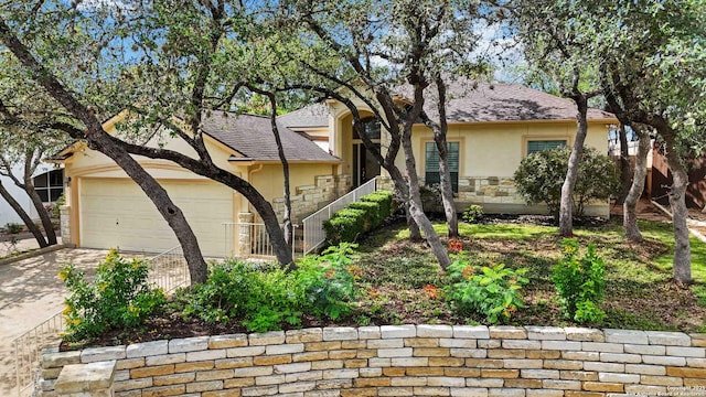 1407 Canyon Edge, San Antonio, TX 78248 - obstructed view of property with stucco siding, stone siding, driveway, and an attached garage