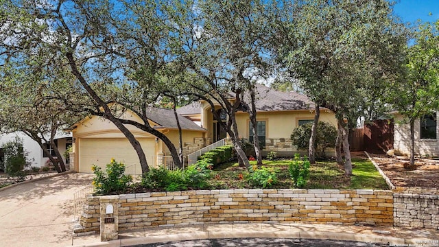 1407 Canyon Edge, San Antonio, TX 78248 - view of property hidden behind natural elements featuring stucco siding, concrete driveway, an attached garage, and stone siding