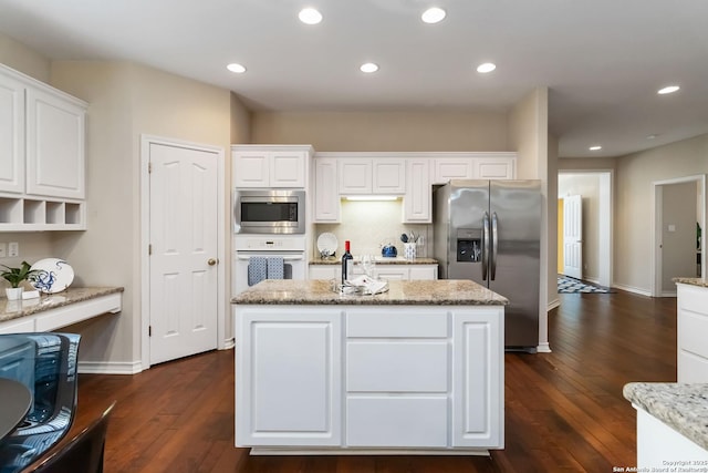 1407 Canyon Edge, San Antonio, TX 78248 - kitchen with stainless steel appliances, white cabinets, dark wood-type flooring, a center island, and recessed lighting