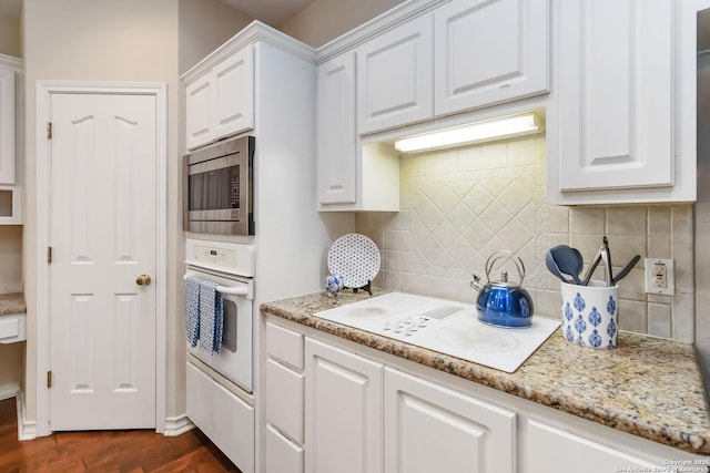 1407 Canyon Edge, San Antonio, TX 78248 - kitchen featuring white appliances, white cabinets, backsplash, dark wood-style floors, and light stone countertops