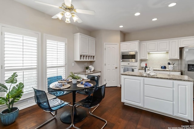 1407 Canyon Edge, San Antonio, TX 78248 - kitchen with stainless steel microwave, oven, white cabinetry, a ceiling fan, and recessed lighting