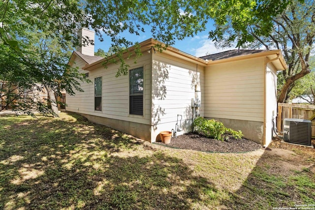 1407 Canyon Edge, San Antonio, TX 78248 - view of side of home with a central AC unit and a chimney