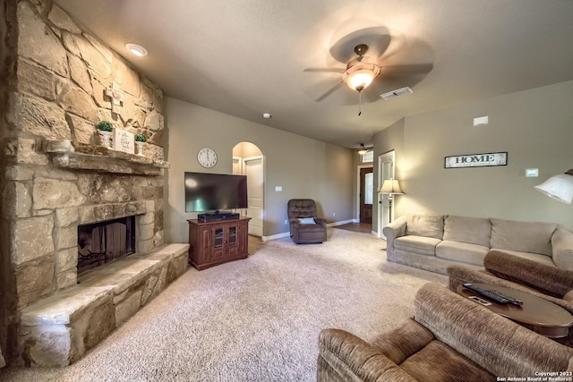 1463 Birch Ln, Fischer, TX 78623 - living area featuring arched walkways, ceiling fan, carpet, and a stone fireplace
