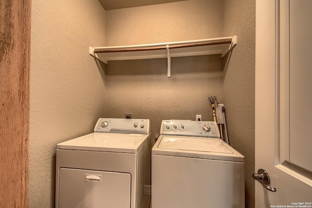 1463 Birch Ln, Fischer, TX 78623 - washroom with separate washer and dryer and a textured wall