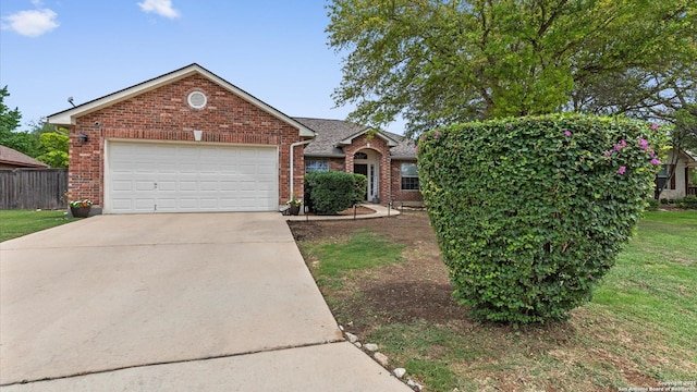 1238 Sugar Land, New Braunfels, TX 78130 - view of front of property featuring a garage, concrete driveway, and brick siding
