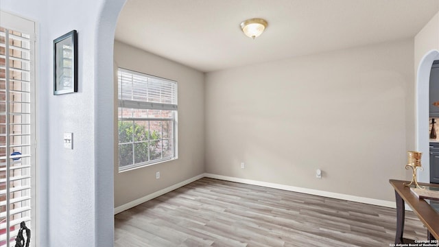 1238 Sugar Land, New Braunfels, TX 78130 - spare room featuring arched walkways and wood finished floors