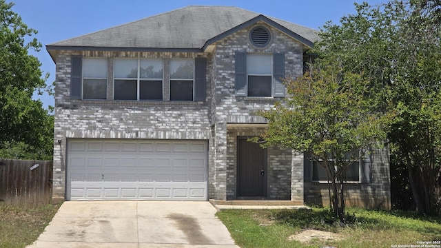 8310 Border Rdg, San Antonio, TX 78240 - view of front of home with driveway, an attached garage, and stone siding