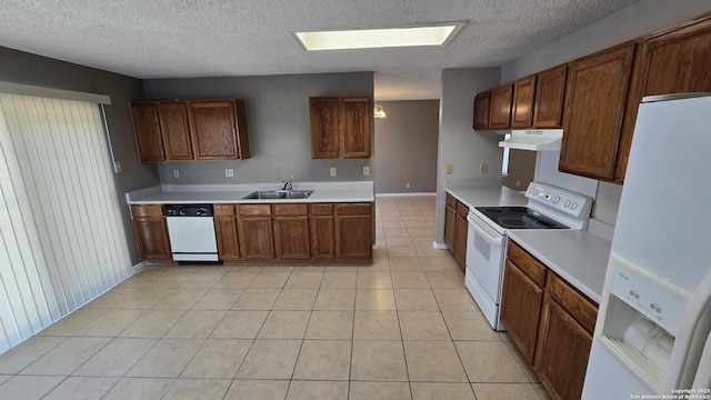8310 Border Rdg, San Antonio, TX 78240 - kitchen with white appliances, under cabinet range hood, light tile patterned flooring, a skylight, and light countertops