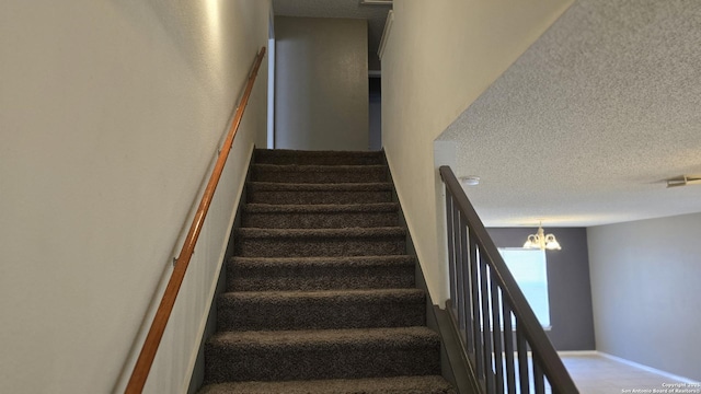 8310 Border Rdg, San Antonio, TX 78240 - stairs featuring a chandelier and a textured ceiling