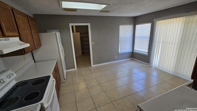 8310 Border Rdg, San Antonio, TX 78240 - kitchen with white appliances, ventilation hood, light tile patterned flooring, a textured ceiling, and light countertops