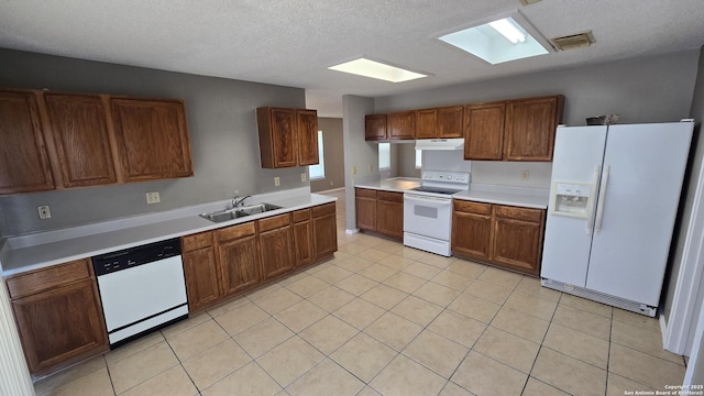 8310 Border Rdg, San Antonio, TX 78240 - kitchen featuring white appliances, range hood, light countertops, a skylight, and a textured ceiling
